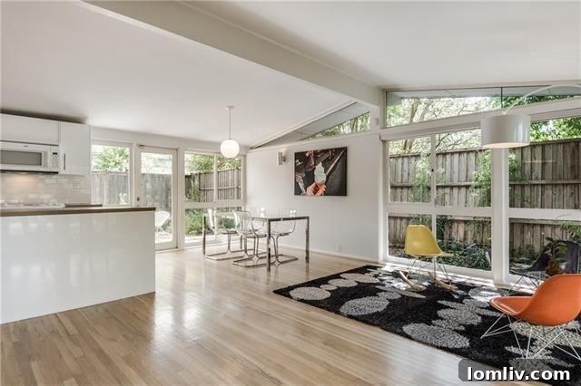 Interior view of the living room with hardwood floors and large windows