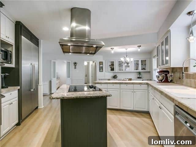 Updated kitchen with natural stone countertops and stainless steel appliances
