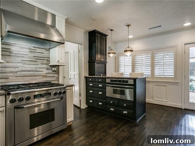 Updated kitchen with glass tile backsplash and gas cooktop in Mockingbird Park home