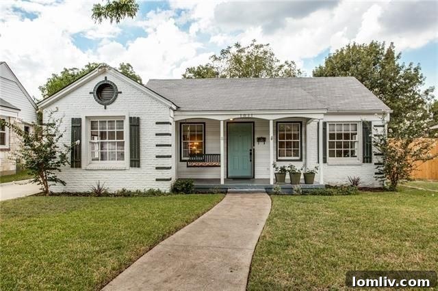 Charming white brick cottage exterior with duck-egg blue door and welcoming porch at 1611 Cascade Ave, Elmwood Dallas