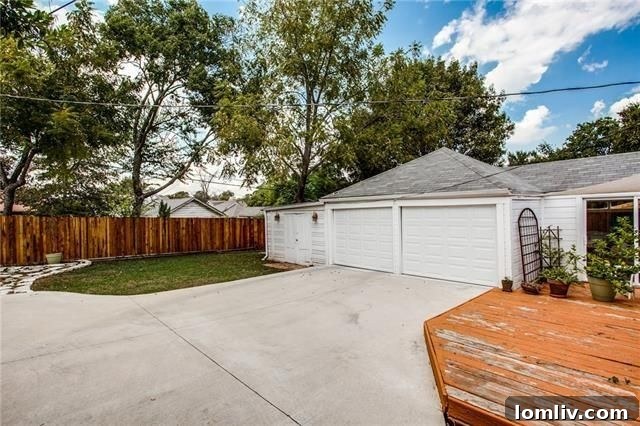 View of the attached garage from the backyard of the Elmwood home