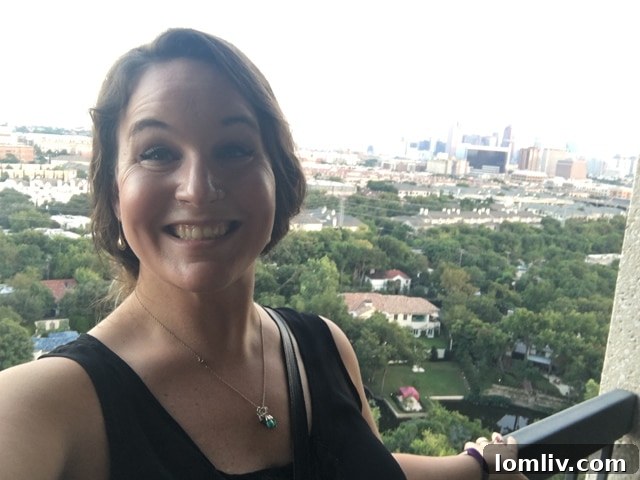 Jo England, daltxrealestate.com editrix, smiling brightly and thoughtfully, clearly considering the momentous move to a high-rise after experiencing The Warrington's appeal.
