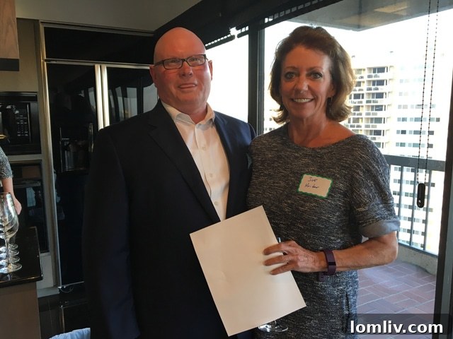 Allie Beth Allman & Associates agent Sue Krider and Briggs Freeman Sotheby's agent Grant Vancleve engaging in a friendly discussion about the luxurious Unit 18E at The Warrington event, showcasing professional camaraderie.