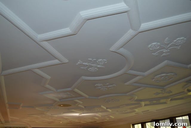 Close-up of a plaster ceiling design at Kimple House, featuring Magnolia blooms.