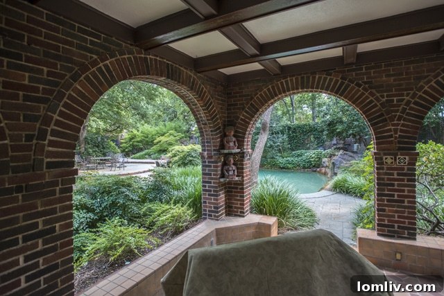 Kimple House backyard featuring a swimming pool, grotto, and lush landscaping.