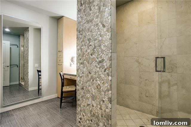 Guest bathroom with custom-tiled shower and frameless glass door