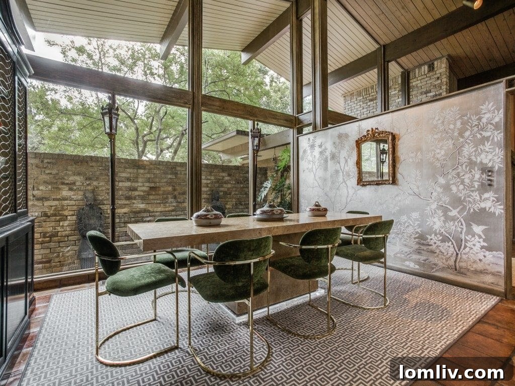 A bright and airy living space at 7115 Brookshire Circle, showcasing floor-to-ceiling windows and high ceilings.
