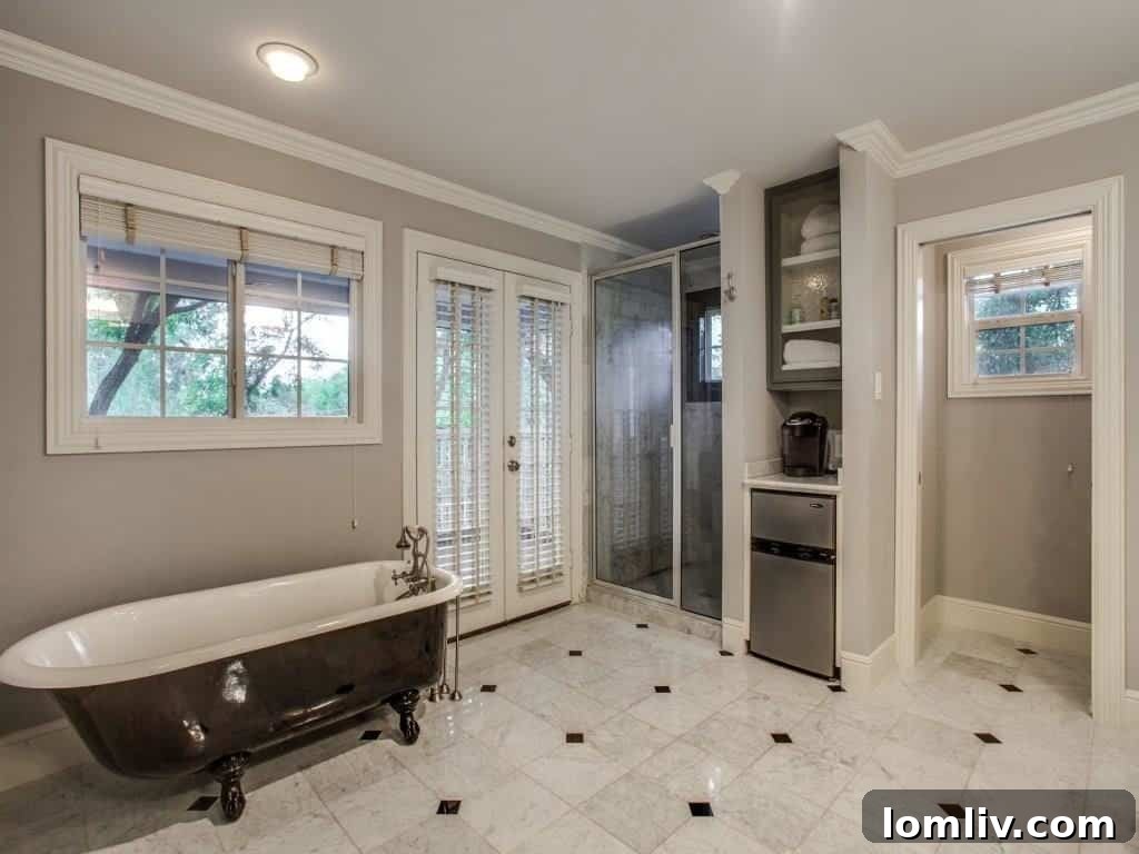 Peninsula Perfection: Adorable Southern Traditional, Steps to White Rock Lake 12 Luxurious master bathroom with dual vanities and modern fixtures