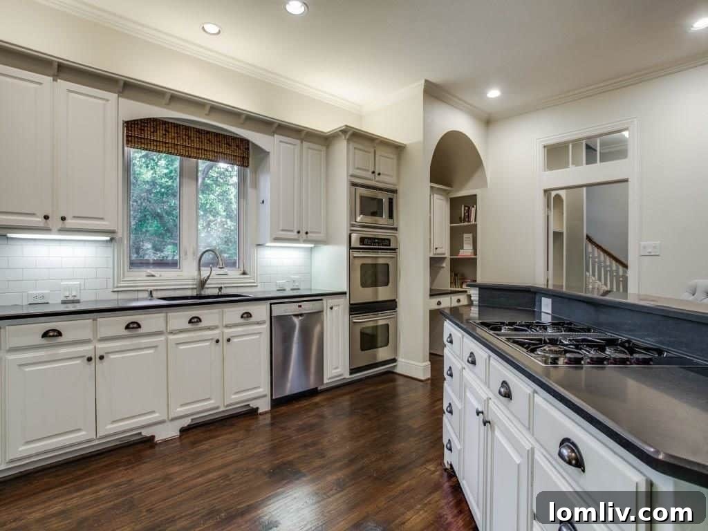 Peninsula Perfection: Adorable Southern Traditional, Steps to White Rock Lake 7 Elegant dining room, currently used as a vibrant playroom