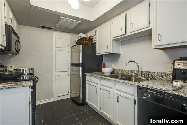 Detailed shot of the kitchen's modern stainless steel appliances including a refrigerator