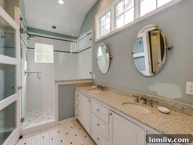 Expansive, light-filled master bathroom featuring a raised ceiling and clerestory windows
