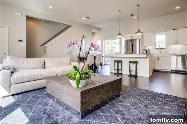 Open-concept living space with vaulted ceilings and abundant natural light in the townhome