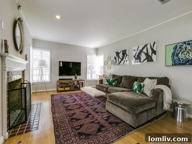 Inviting living room with classic fireplace and hardwood floors in East Kessler