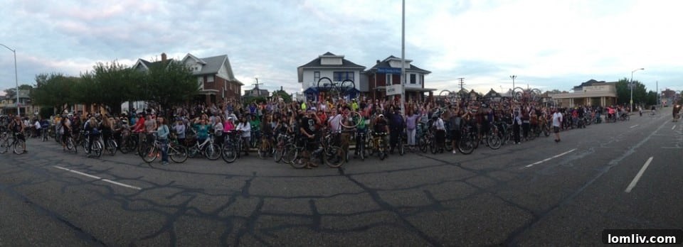 Large group of Slow Roll Detroit cyclists stretching around a city block