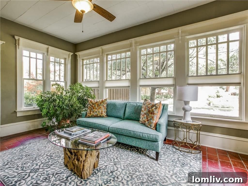 Sun-drenched solarium, ideal for relaxation, a reading nook, or a vibrant home office, with large windows overlooking the yard.