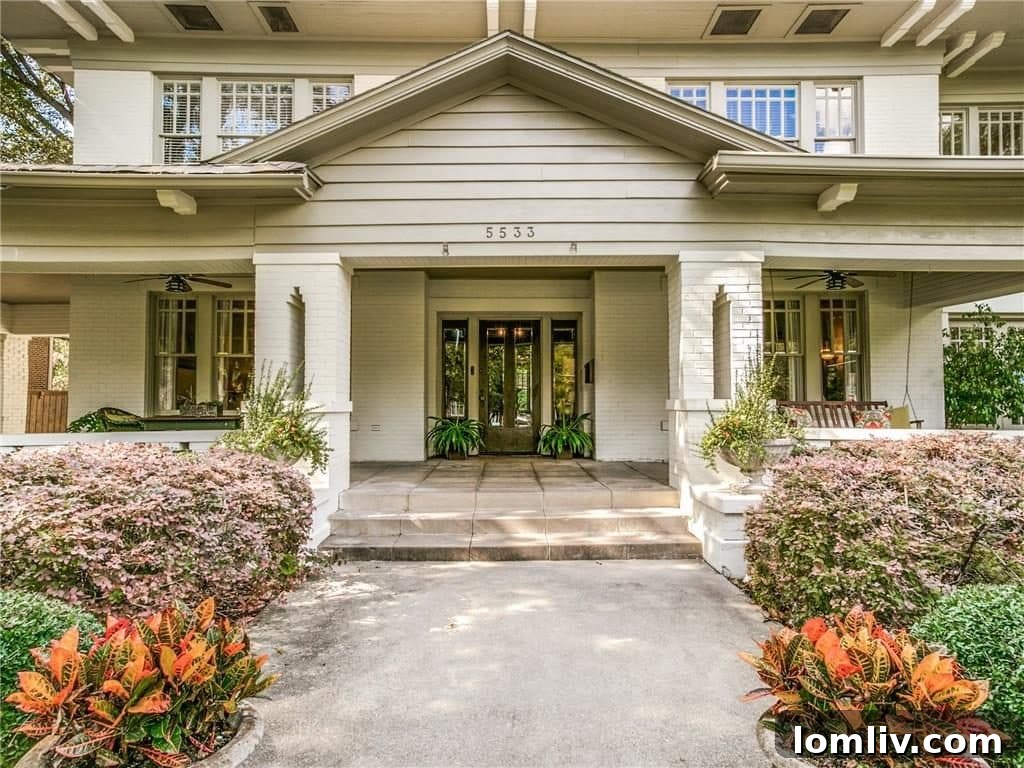 Inviting front porch of the historic Swiss Avenue house, featuring comfortable seating and classic architectural details.