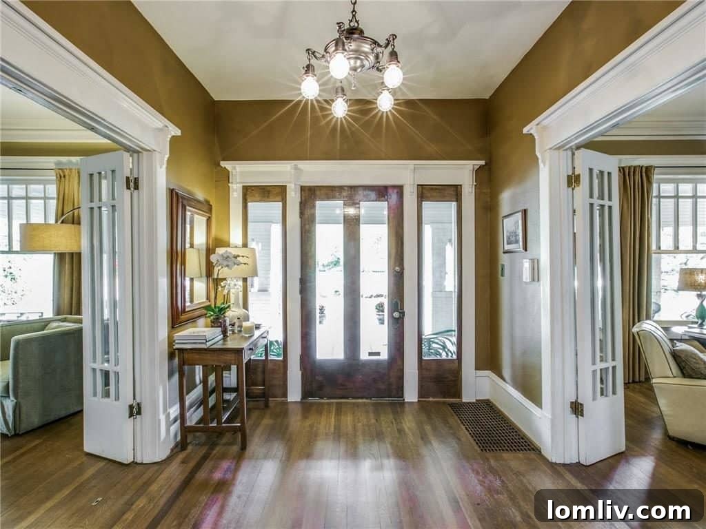 Grand entryway with period details, gleaming hardwood floors, and an elegant staircase, creating a welcoming first impression.