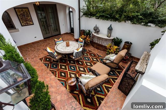 Discover the serene outdoor living space at 4067 West 7th Street, featuring a private fireplace and elegant terra cotta flooring.