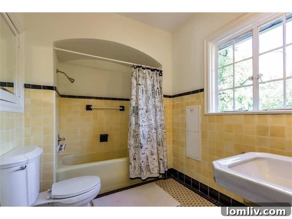 Original vibrant bathroom tiles, perfectly preserved, showcasing the distinct character of the Tudor home's period elegance.