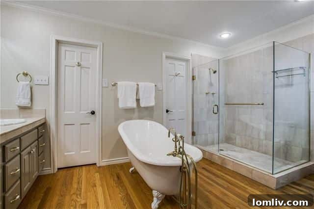 Luxurious Master Bathroom with Claw Foot Tub and Frameless Shower