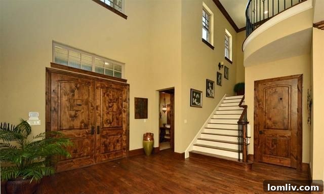 Elegant Two-Story Entryway of Honeysuckle Court Lake House, showcasing premium finishes