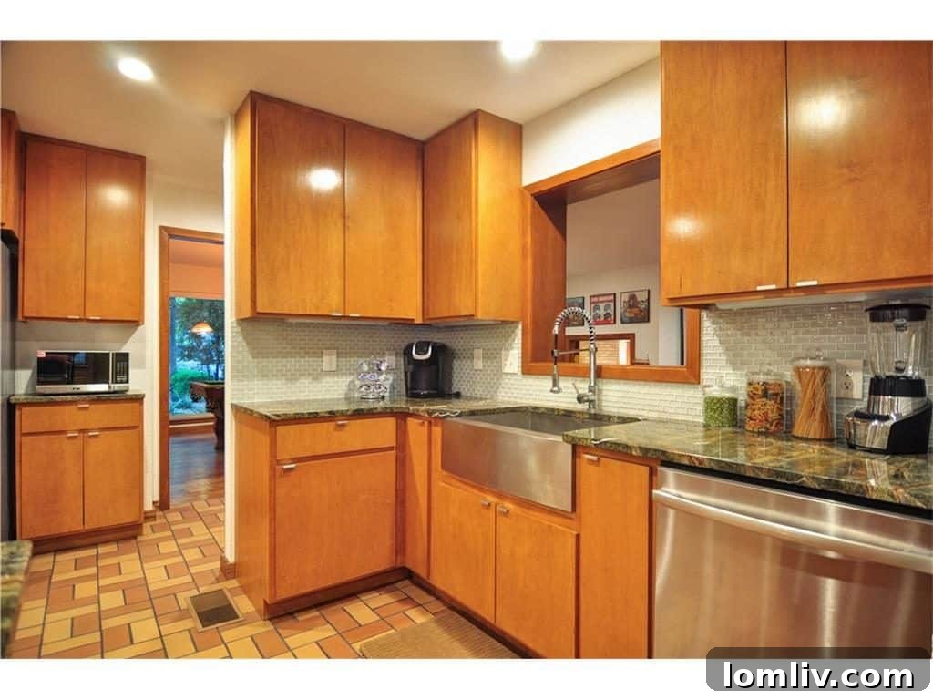 Serpentine marble countertops in 'Rainforest Green' enhance the midcentury aesthetic