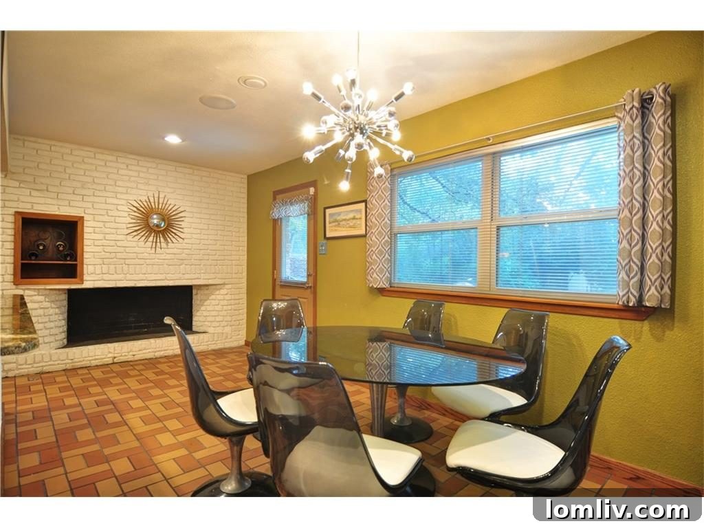 Elegant dining area with unique brick tile flooring and midcentury furnishings