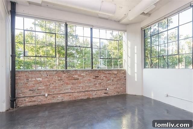 Large windows offering natural light in loft bedroom area