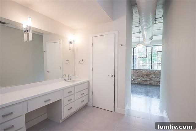 Enormous marble-topped vanity in renovated master bathroom