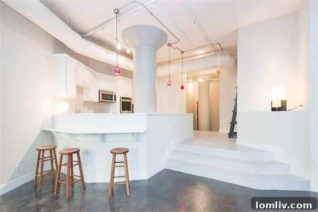 Modern breakfast bar with pendant lighting in Dallas loft kitchen