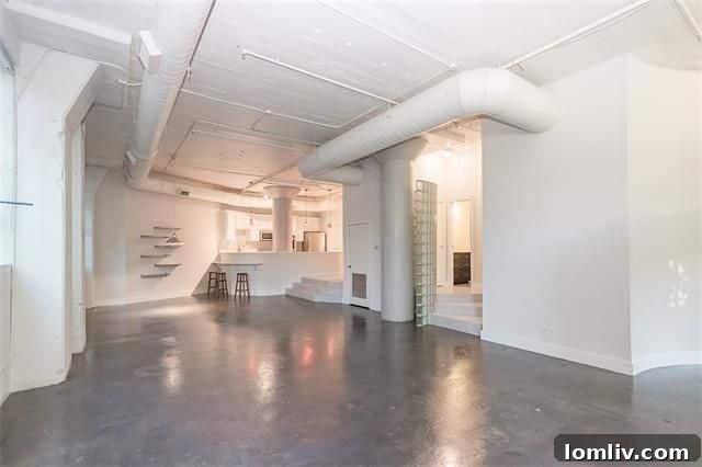 Spacious living area with high ceilings and natural light in 2220 Canton loft
