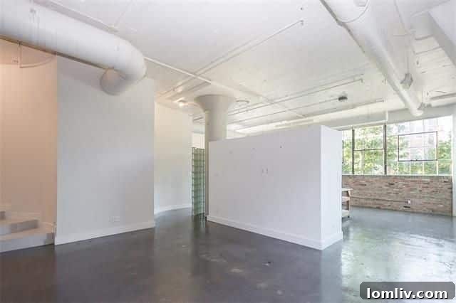 Open bedroom area in Dallas loft with partial walls