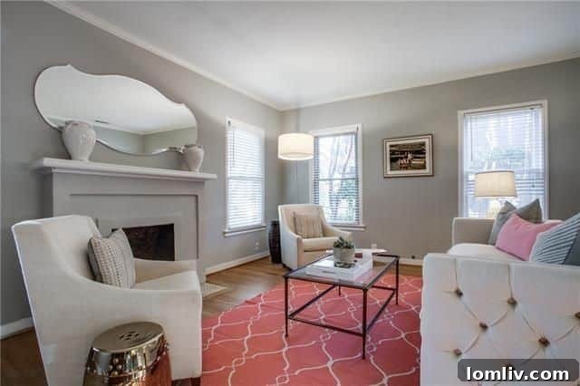 Belmont Craftsman Shines Bright in This Week's Dallas Open House Roundup 19 Inviting living room with a neutral gray palette, decorative fireplace, and hardwood floors in the Hollywood Heights Tudor.