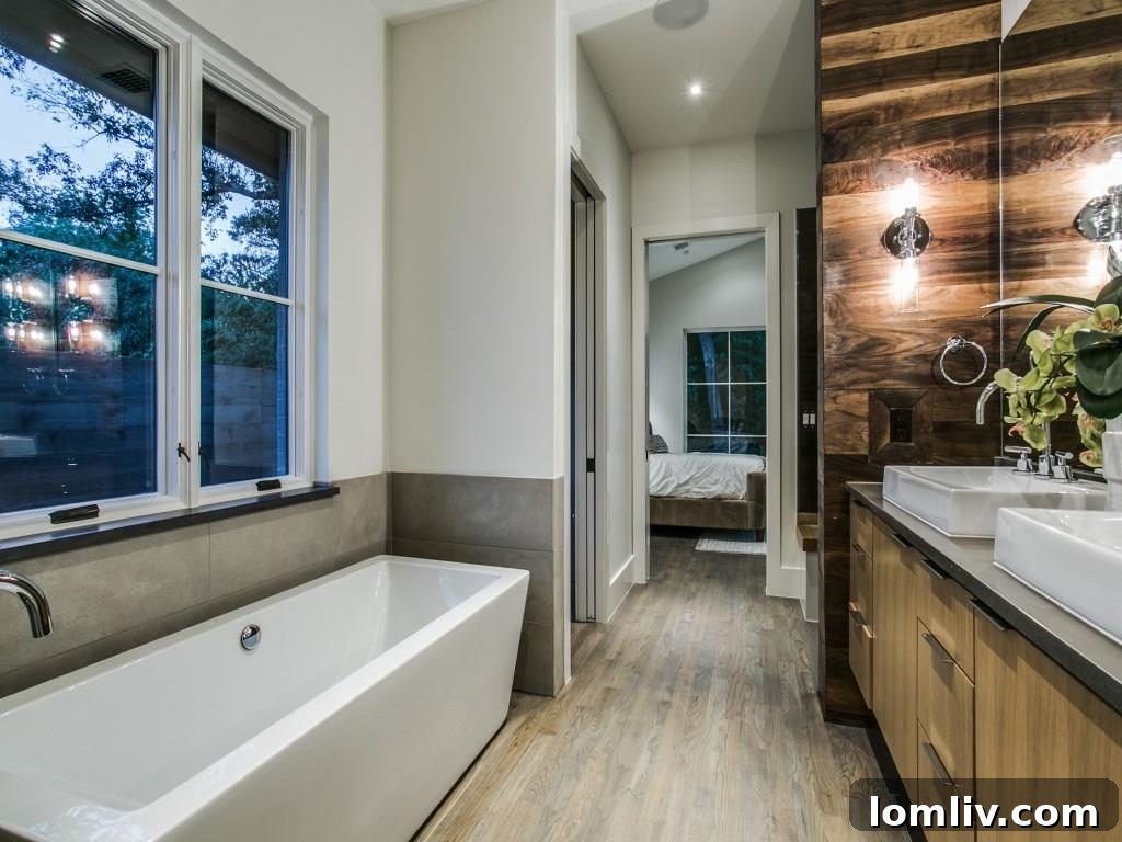 Lakewood Creekside Farmhouse: Modern Texas Living 15 Luxurious master bathroom with elegant walnut accent walls and modern fixtures.