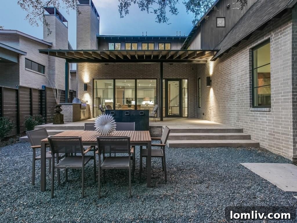 Lakewood Creekside Farmhouse: Modern Texas Living 19 View of the expansive backyard with lush greenery and the modern house exterior.