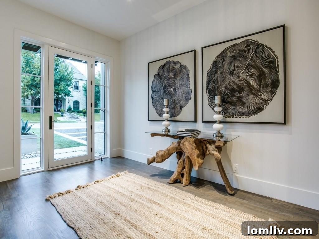 Front entrance of the modern farmhouse, showcasing the unique gravel landscaping and custom triple fountain.