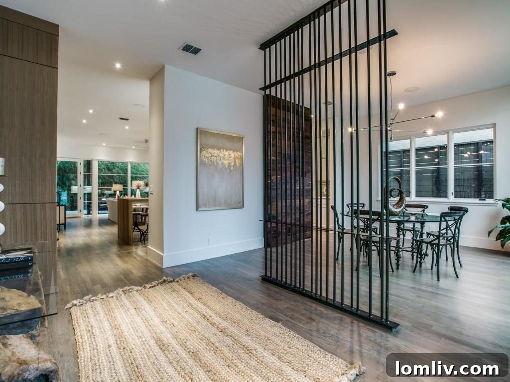 Lakewood Creekside Farmhouse: Modern Texas Living 5 Elegant hand-forged steel room divider separating the entry from the dining area.