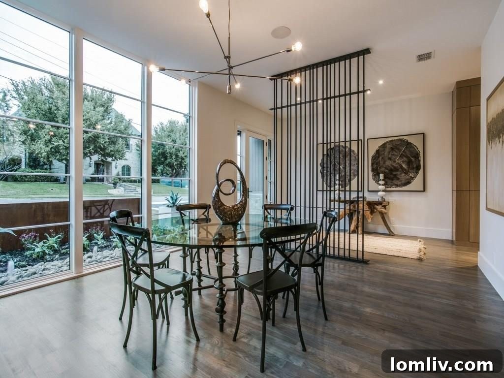 Lakewood Creekside Farmhouse: Modern Texas Living 6 View of the dining room with the custom steel divider and natural light.