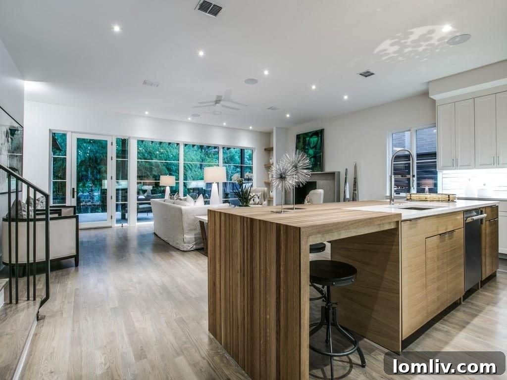 Lakewood Creekside Farmhouse: Modern Texas Living 10 Spacious kitchen area with views of the natural surroundings, featuring high-end Thermador appliances.