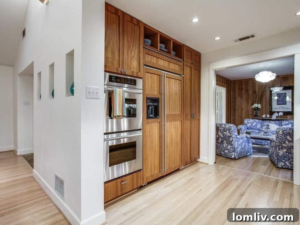 Frank Welch Protégé Redefines Texas Contemporary in Lake Park Estates 13 Another angle of the contemporary kitchen, showcasing clever storage solutions and high-quality fixtures.