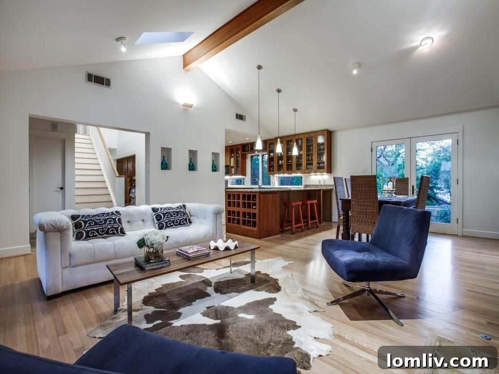 Frank Welch Protégé Redefines Texas Contemporary in Lake Park Estates 9 Detailed shot of the stone fireplace and vaulted ceiling, emphasizing the architectural prowess and quality craftsmanship.