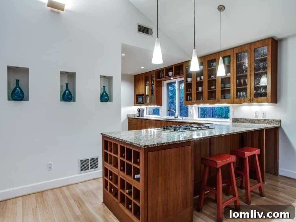 Frank Welch Protégé Redefines Texas Contemporary in Lake Park Estates 10 High-end gourmet kitchen featuring warm cherry cabinets, modern appliances, and ample counter space for culinary endeavors.