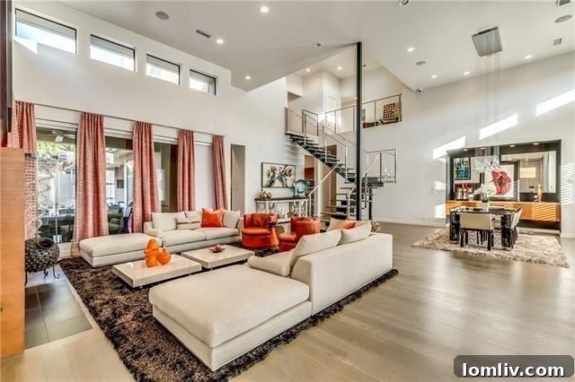 Grand living room with vaulted ceilings and staircase at 17 Winding Lake Dr.