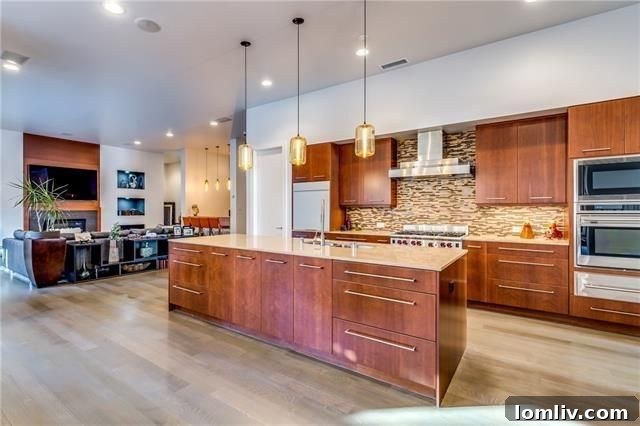 Sleek, modern kitchen with large island and stainless steel appliances at 17 Winding Lake Dr.