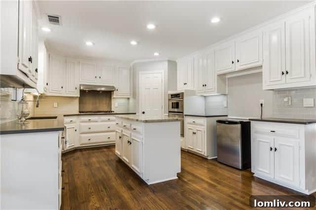 Modern kitchen with quartz countertops and Viking cooktop at 7018 Lattimore Dr.