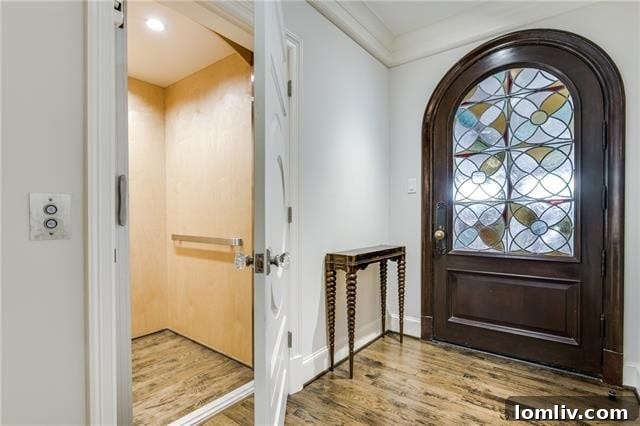 Stained glass door leading to an elevator from the climate-controlled garage