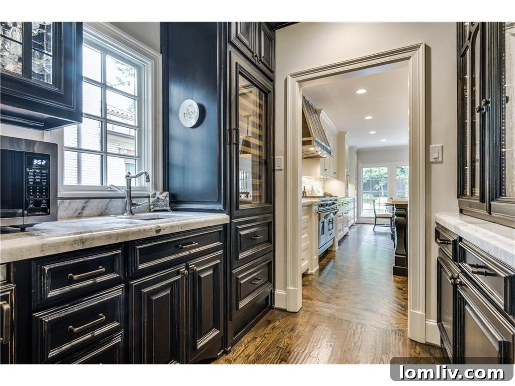 Grand sweeping staircase with intricate ironwork and polished wood, connecting the home's levels