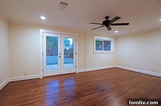 Spacious master bedroom at 1122 Brunner, featuring hardwood floors and direct access to the back deck.