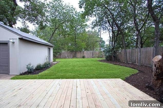 View of the spacious backyard and detached two-car garage at 1122 Brunner.