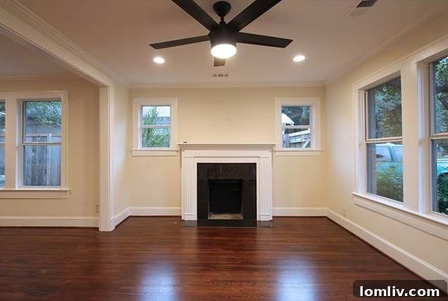 Bright and spacious living room at 1122 Brunner, featuring refinished hardwood floors and ample natural light.